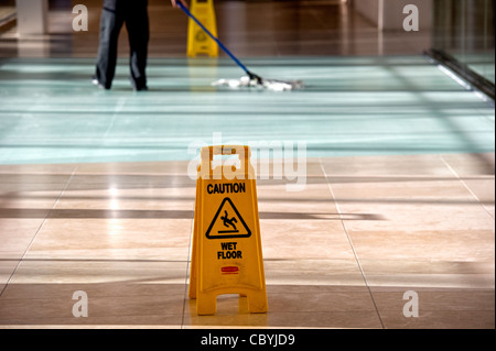 Office cleaner using mop Stock Photo