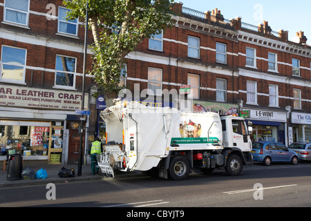 veolia workers working on behalf of local brent council collecting refuse waste in a bin lorry london uk united kingdom Stock Photo