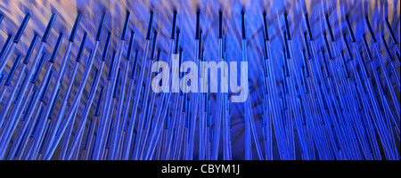 Blue light abstract background of a lighting display applied to random leaning rods & bars replicating technology theme with a hint of water jet spray Stock Photo