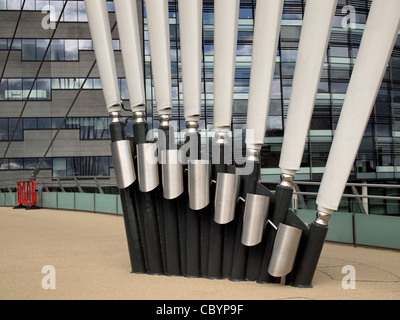 Radiating bridge cable supports at Salford Quays against background of reflections in glasswith red barrier on bridge Stock Photo