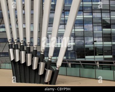 Radiating bridge cable supports at Salford Quays against background of reflections in glass Stock Photo