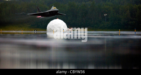 The F-22A Raptor takes off with afterburners during a demonstration Aug. 20 at Elmendorf Air Force Base, Alaska. The demo was the closing event of the 90th Fighter Squadron's 90th anniversary. The aircraft was flown by Maj. Paul Moga, the Air Force's sole F-22 demonstration pilot. He is assigned to the 1st Operations Group at Langley AFB, Va Stock Photo