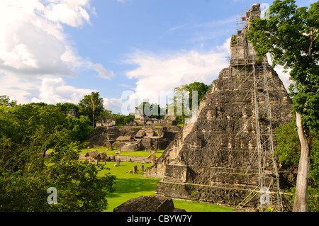 Temple 1, also known as the Temple of the Great Jaguar or Temple of Ah Cacao in the Tikal Maya ruins in northern Guatemala, now enclosed in the Tikal National Park. At the left of frame is the Main Plaza. On the side of the temple is some of the scaffolding that archeologists are using to restore the temple. Stock Photo