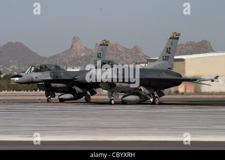 From the end of the runway at Tucson International Airport, an F-16 Fighting Falcon instructor pilot with the Arizona Air National Guard's 162nd Fighter Wing prepares to take off with his wingman, an international student pilot training with the Guard unit. Stock Photo