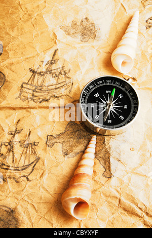 Compass and shells on old marine map Stock Photo