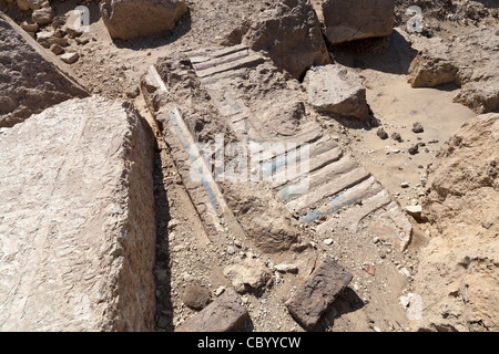 Painted decorated lintel in the dust and sand at Ptolemaic Temples in Wanina, Akhmim in the Governorate of Sohag, Middle Egypt Stock Photo