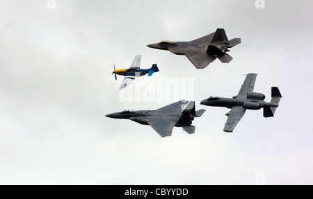 A heritage flight with a P-51 Mustang, F-15 Eagle, F-22 Raptor and A-10 Thunderbolt II fly over the crowd at the Arctic Thunder air show at Elmendorf Air Force Base, Alaska, on Aug. 12. The two-day event drew nearly 136,000 visitors. Stock Photo