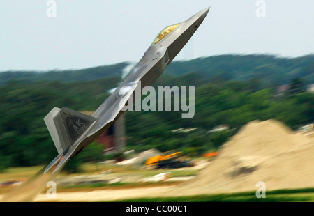 Maj. Paul 'Max' Moga, the first F-22A Raptor Demonstration Team Pilot, does a max climb seconds after aircraft takeoff during an aircraft demonstration July 13. Stock Photo