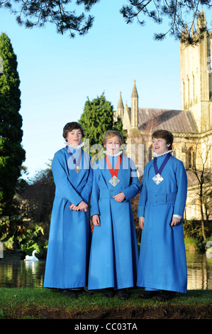 Boy choristers from the Wells Cathedral Choir in Somerset UK take a break from rehearsals by 'The Wells' pond after which the ci Stock Photo