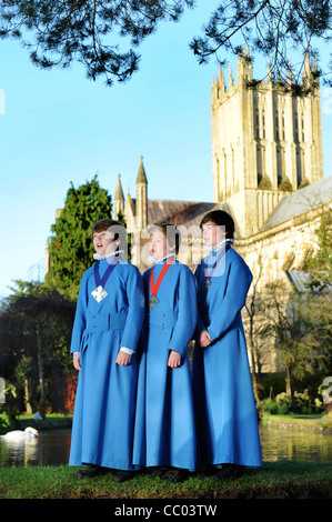 Boy choristers from the Wells Cathedral Choir in Somerset UK take a break from rehearsals by 'The Wells' pond after which the ci Stock Photo