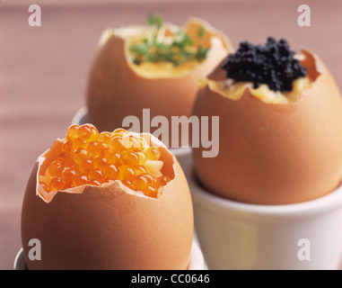 Scrambled egg in the peel, filled with keta caviar, trout caviar and cress Stock Photo