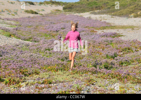LITTLE GIRL RUNNING THROUGH THE SEA LAVENDER, BAY OF SOMME, SOMME (80), FRANCE Stock Photo
