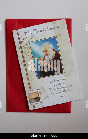 With Deepest Sympathy card with red envelope isolated on white background Stock Photo