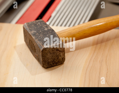 Large steel pound hammer on workbench in close up Stock Photo
