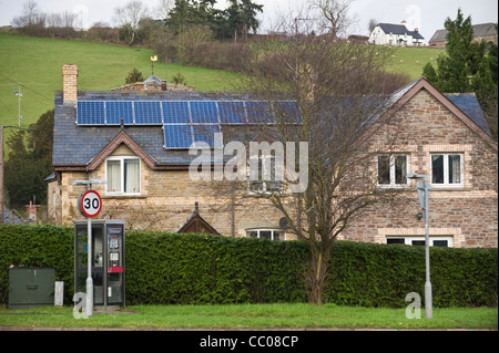 Solar panels fitted to roof of rural detached period house in Clyro Powys Wales UK Stock Photo