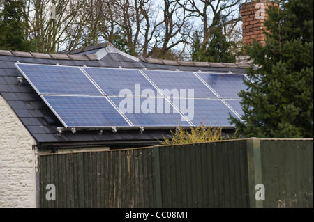 Solar panels fitted to roof of rural detached cottage in Winforton Herefordshire England UK Stock Photo