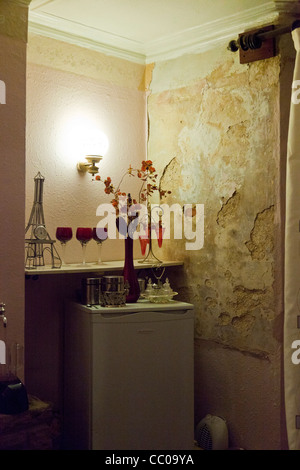 damp wall causing plaster to fall off Stock Photo
