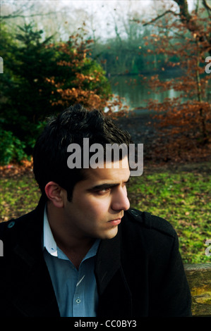 Serious Asian man outdoors looking away Stock Photo