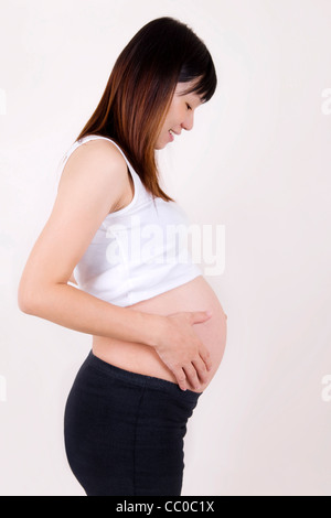 8 months pregnant Asian woman.