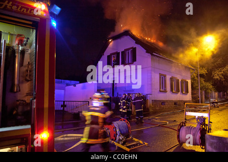 FIREFIGHTERS FIGHTING A HOUSE FIRE AT NIGHT IN THE SUBURBS OF MULHOUSE, HAUT-RHIN (68), FRANCE Stock Photo