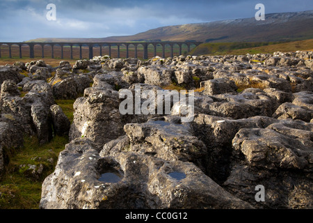 Pavement Puddles Limestone Pavement at the Ribblehead Viaduct across the River Ribble at Ribblehead , in North Yorkshire, UK Stock Photo