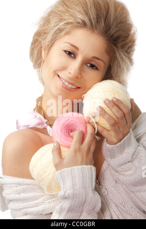 Happy woman holding wool knitting clews with professional make up and hair style isolated on white Stock Photo