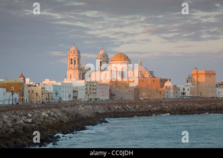 View of Cadiz harbour with Catedral Nueva in golden late-afternoon light. Stock Photo