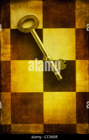 Old key over a chess board Stock Photo