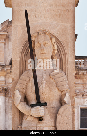 The Roland statue was erected in medieval armor. In the background there is the Municipal belfry, Dubrovnik, Croatia, Europe Stock Photo