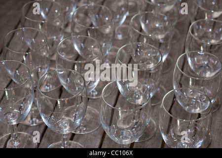 rows of empty wine glasses on a table Stock Photo