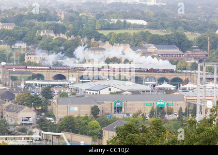 Steam locomotive pulling a passenger train on the mainline at Huddersfield Stock Photo