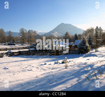 Famous russian tourist village Zamulta in winter in Uimon Valley, Altai mountains. Stock Photo