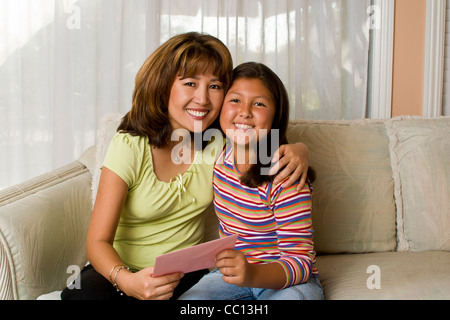 Mother’s Day diversity racially diverse receives greeting card from her 10-11 year old Korean/Caucasian Stock Photo