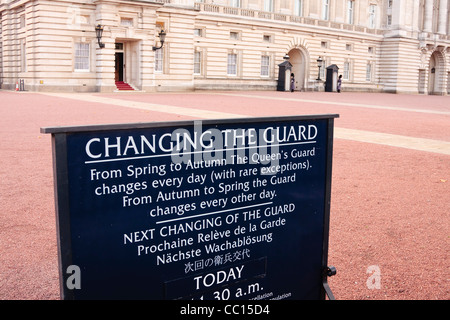 Buckingham Palace, London, UK – Changing the Guard sign at front with Queen's Guard in background Stock Photo