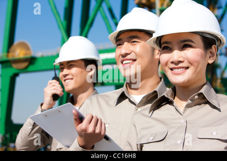 shipping industry workers looking in the distance Stock Photo
