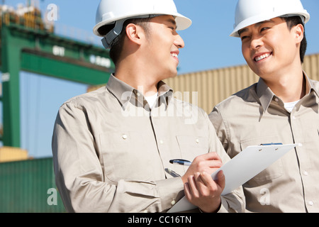 Male shipping industry workers working together Stock Photo