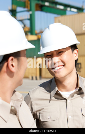 Male shipping industry workers working together Stock Photo