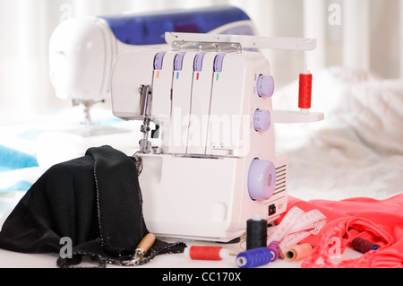 overlock and sewing machine is on the table Stock Photo