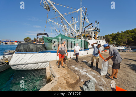 Loading salt, fishing boats moored in Mandre on Pag island, Croatia Stock Photo
