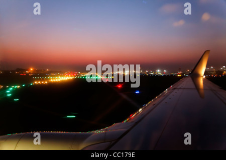 Horizon landscape of night time runway lights Mumbai International Airport during take off, crop margins, copy space empty area Stock Photo