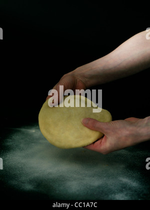 making pizza dough shaping pizza Stock Photo