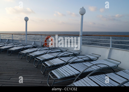 Sun loungers and lifebelt on the deck of the Fred Olsen cruise ship MS Boudicca Stock Photo