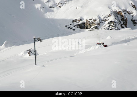 A piste machine making a track on a tow line Stock Photo