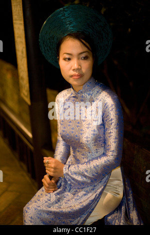 A traditional singer in local costume prepares to perform in a house in  Hue Vietnam Stock Photo
