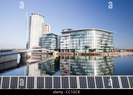 Media city the home of the BBC in the north at Salford Quays, Manchester, UK, reflected in the Manchester Ship Canal. Stock Photo