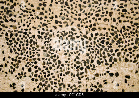 Wall decorated with small flint stones. Architecture background details. Stock Photo