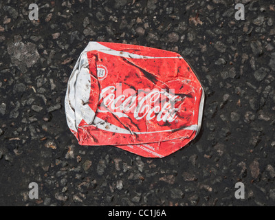 Flat, dirty and wrinkled Coca-Cola aluminum can on the street. FOR EDITORIAL USE ONLY. Stock Photo