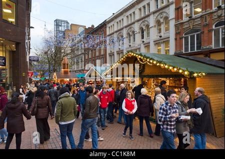 Crowds of last minute Christmas shoppers in front of Frankfurt German Christmas Market, New Street, Birmingham, UK Stock Photo