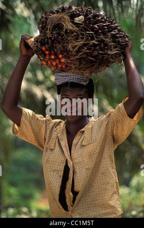 woman carrying basket of palm oil on her head Stock Photo