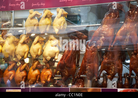 siu mei roasted bird meats hanging in a restaurant window hong kong hksar china asia Stock Photo